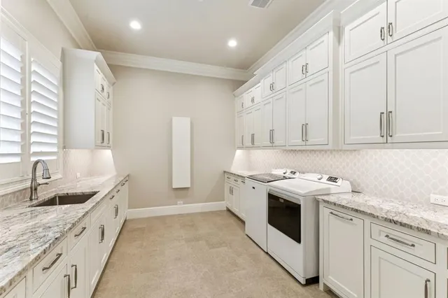 a kitchen with granite countertop white cabinets and white appliances