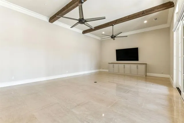 a view of an empty room with a fireplace and a window