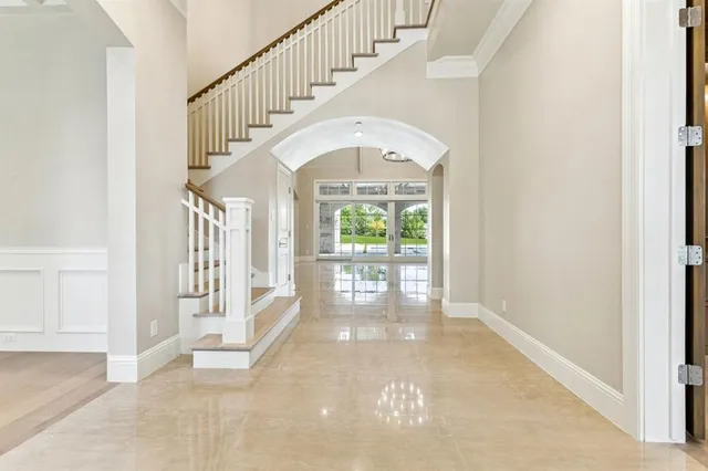 a view of entryway and hall with wooden floor