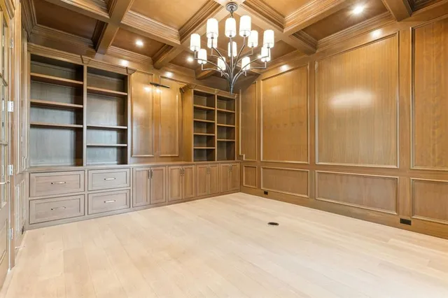 a view of an empty room with cabinet and a window