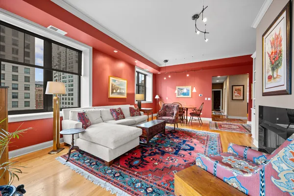 a living room with furniture a rug and a chandelier