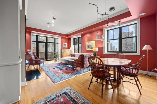 a living room with furniture a rug and a large window