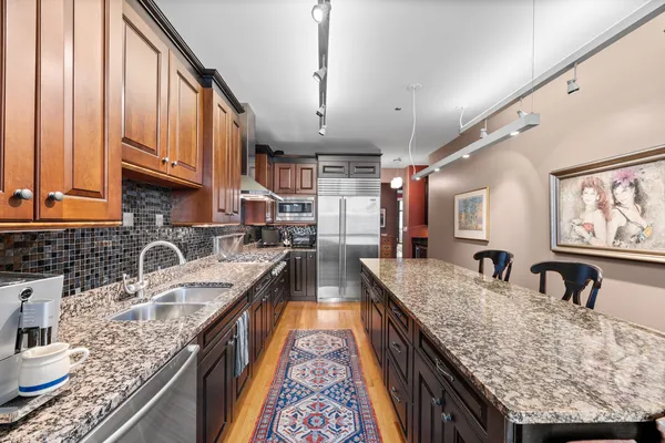 a kitchen with granite countertop a sink and a stove