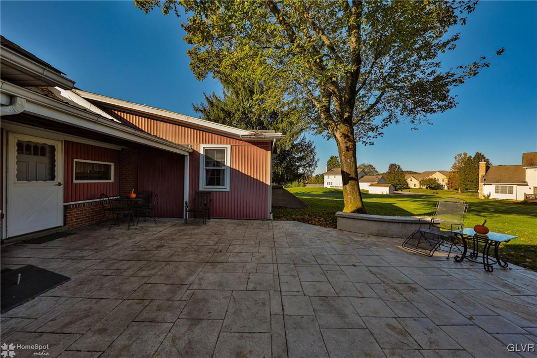 526 West Moorestown Road Nazareth, PA 18064 - Photo 44 of 50 a view of a patio with table and chairs a fire pit and large trees