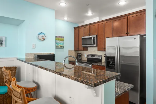 a kitchen with a refrigerator a stove a sink and a microwave