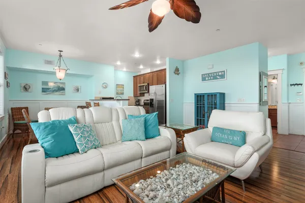 a living room with furniture kitchen view and a table
