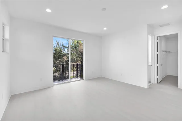 an empty room with large windows