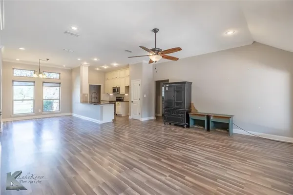 a view of a livingroom with furniture and a ceiling fan