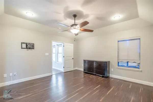 wooden floor in an empty room with a fireplace