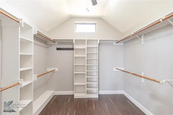 a view of walk in closet with empty racks