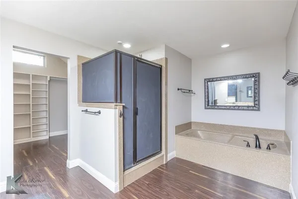 a bathroom with a bathtub and a shower