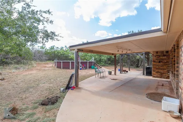 a view of a backyard with sitting area