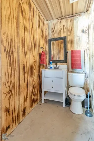 a bathroom with a toilet sink and shower curtain