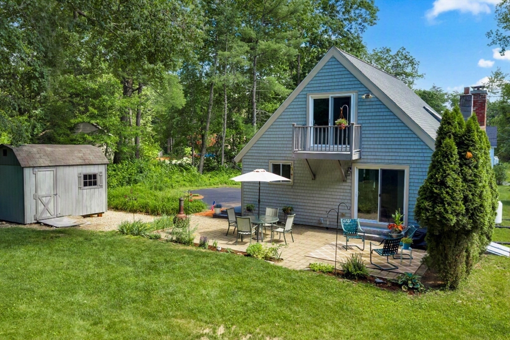 47 Horseshoe Circle Ware, MA 01082 - Photo 6 of 37 a backyard of a house with table and chairs plants and large tree