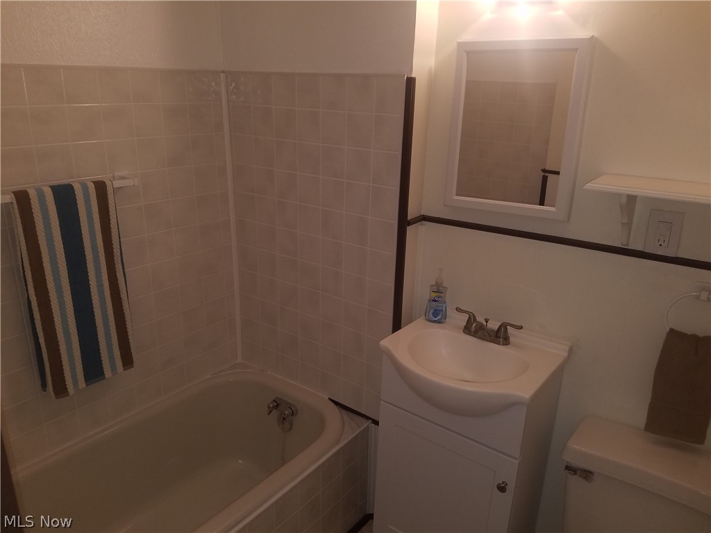 4695 Middle Ridge Road Perry, OH 44081 - Photo 22 of 28 Master bath. New vanity, sink, mirror, lights, floor, and tub surround also fresh paint.