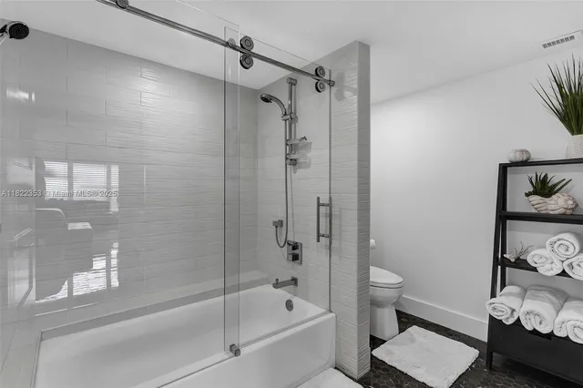 a bathroom with a bathtub a toilet and a shower