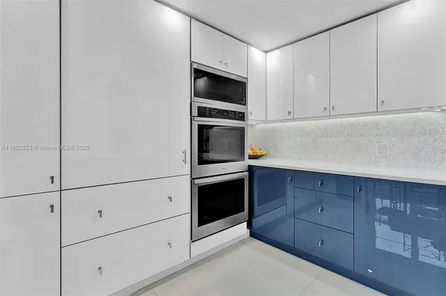 a kitchen with cabinets stainless steel appliances and counter space