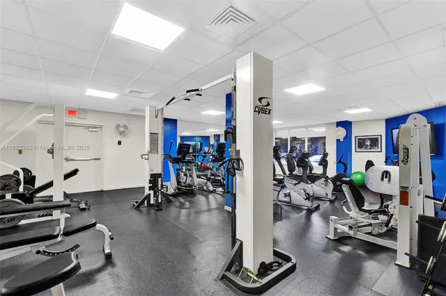 a view of a dining room with furniture large windows and wooden floor