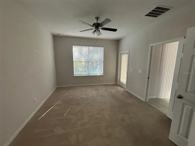 a view of an empty room with a window