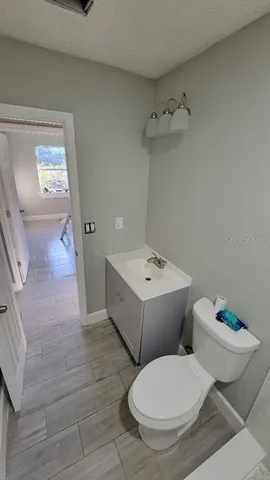 a white toilet sitting next to a bathroom sink