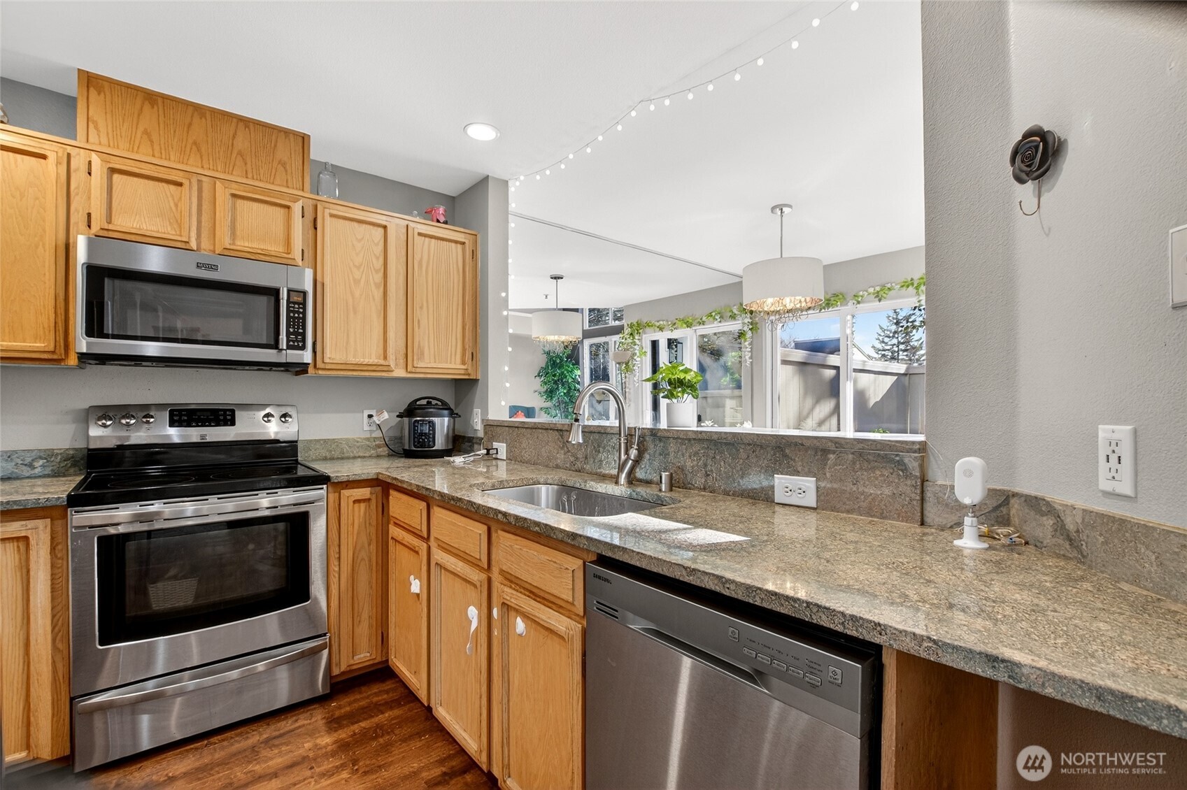 6615 South 239th Place, Unit R109 Kent, WA 98032 - Photo 16 of 40 a kitchen with a sink stove and microwave
