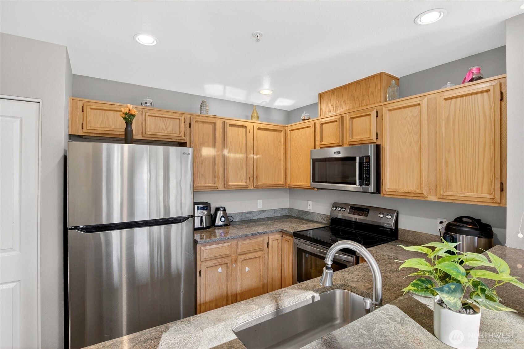 6615 South 239th Place, Unit R109 Kent, WA 98032 - Photo 20 of 40 a kitchen with stainless steel appliances granite countertop a refrigerator sink and stove