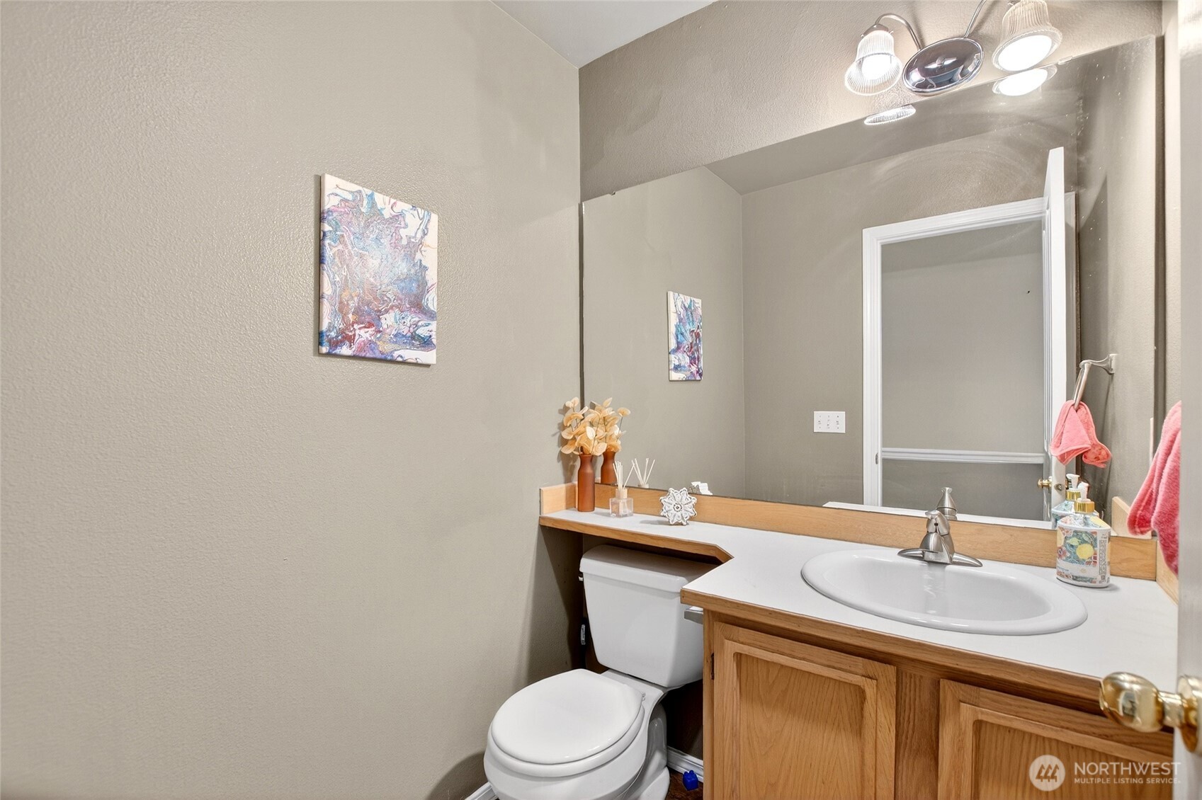 6615 South 239th Place, Unit R109 Kent, WA 98032 - Photo 21 of 40 a bathroom with a granite countertop toilet sink and mirror