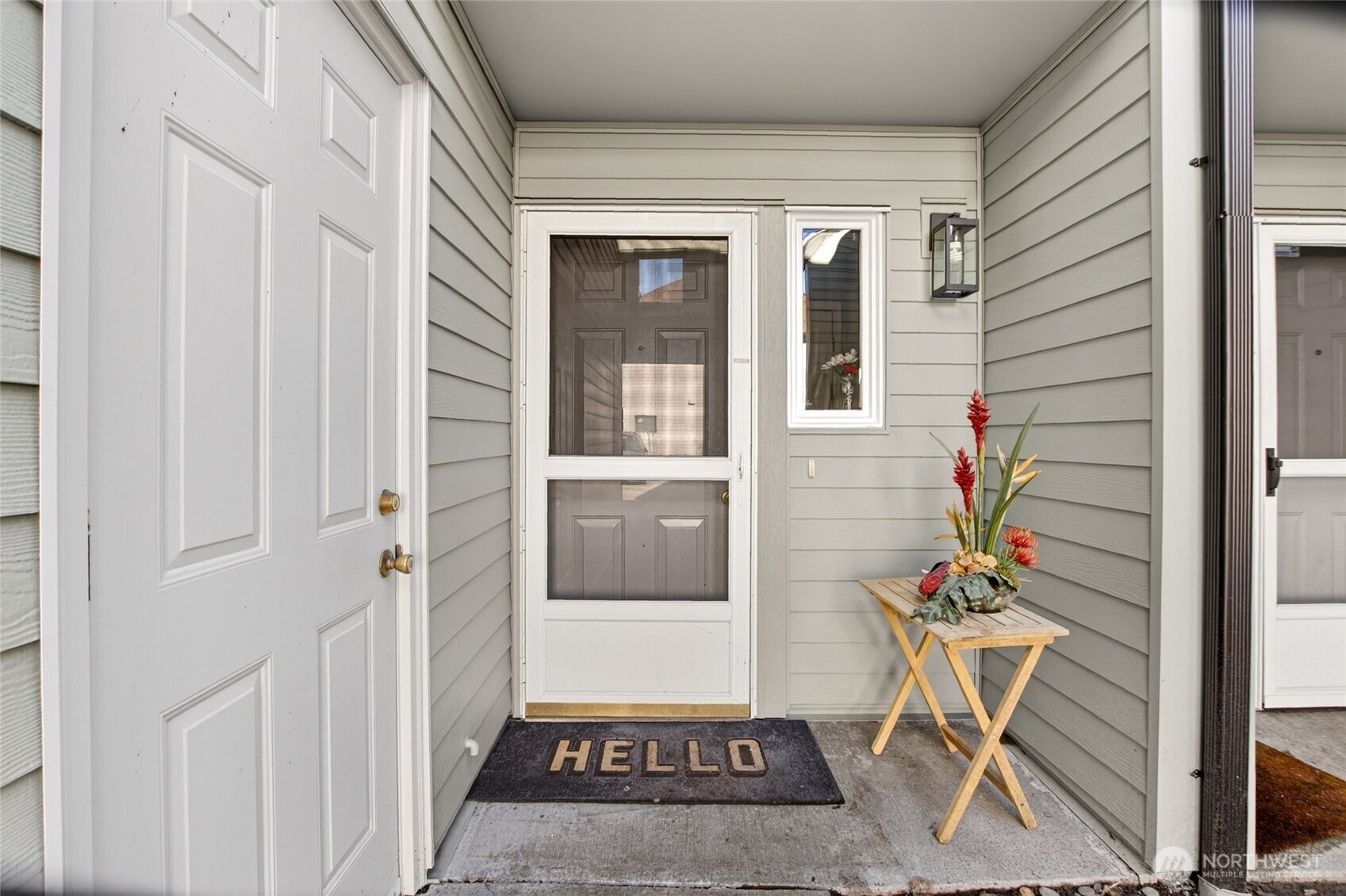 6615 South 239th Place, Unit R109 Kent, WA 98032 - Photo 3 of 40 a porch with a bench and a table
