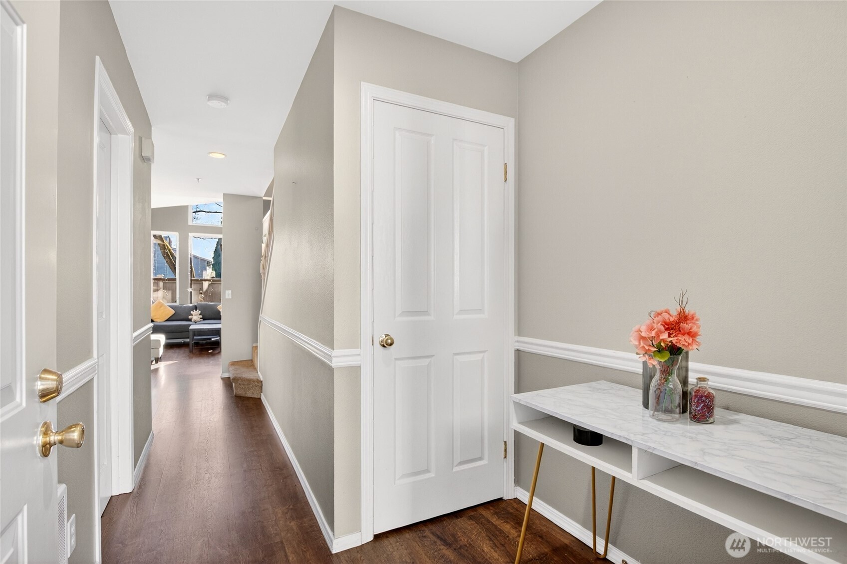 6615 South 239th Place, Unit R109 Kent, WA 98032 - Photo 4 of 40 a view of a hallway with wooden floor and furniture