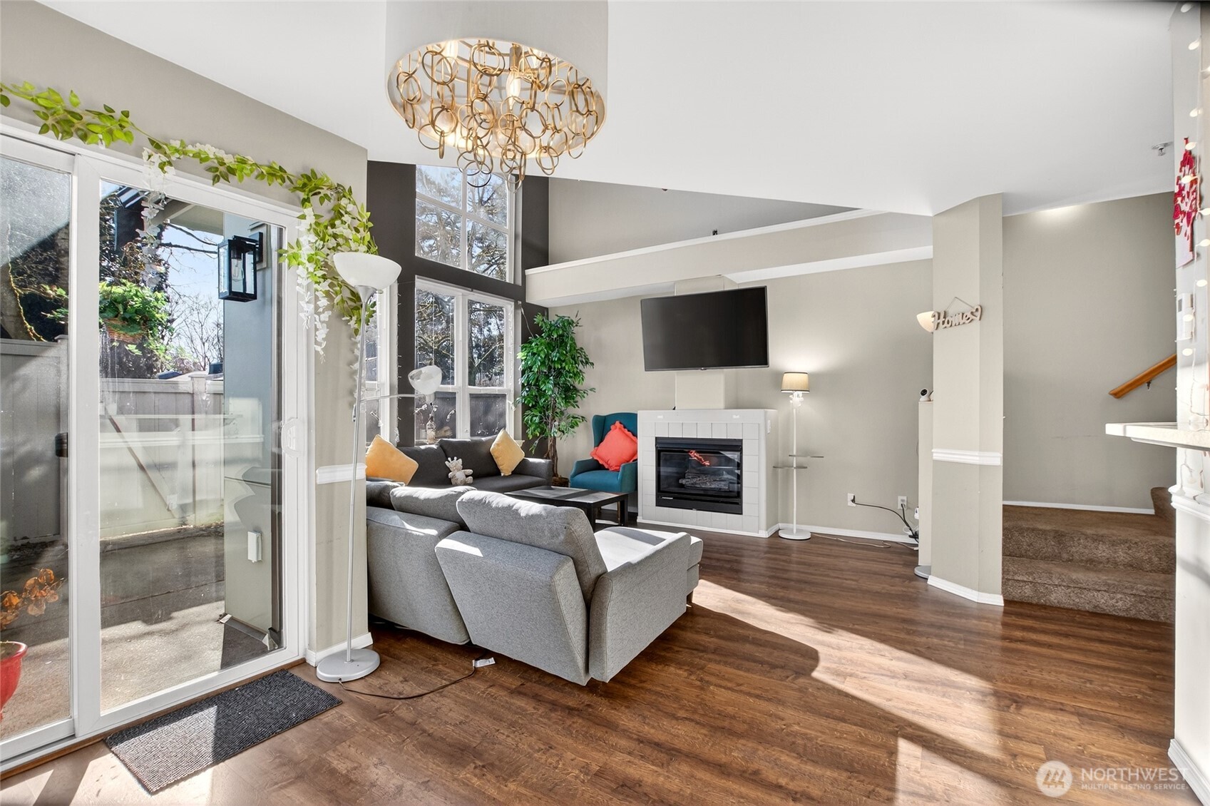 6615 South 239th Place, Unit R109 Kent, WA 98032 - Photo 6 of 40 a living room with furniture a fireplace and a chandelier