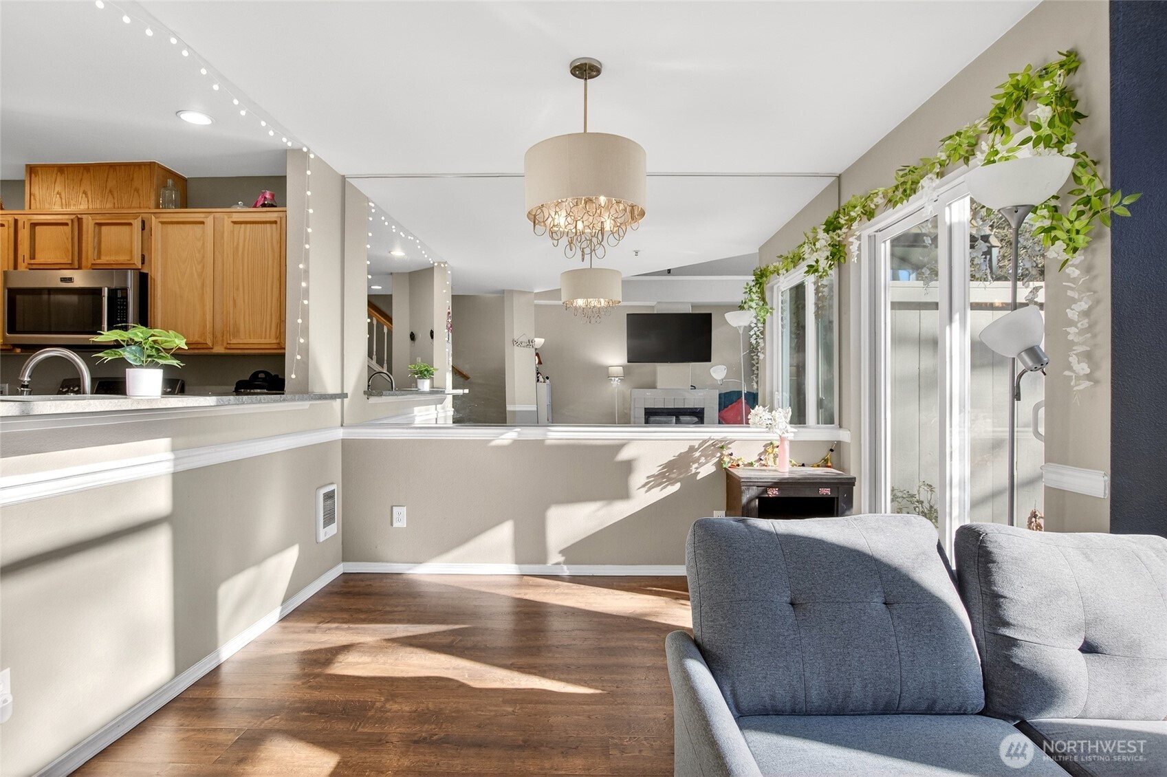 6615 South 239th Place, Unit R109 Kent, WA 98032 - Photo 7 of 40 a living room with furniture and a chandelier