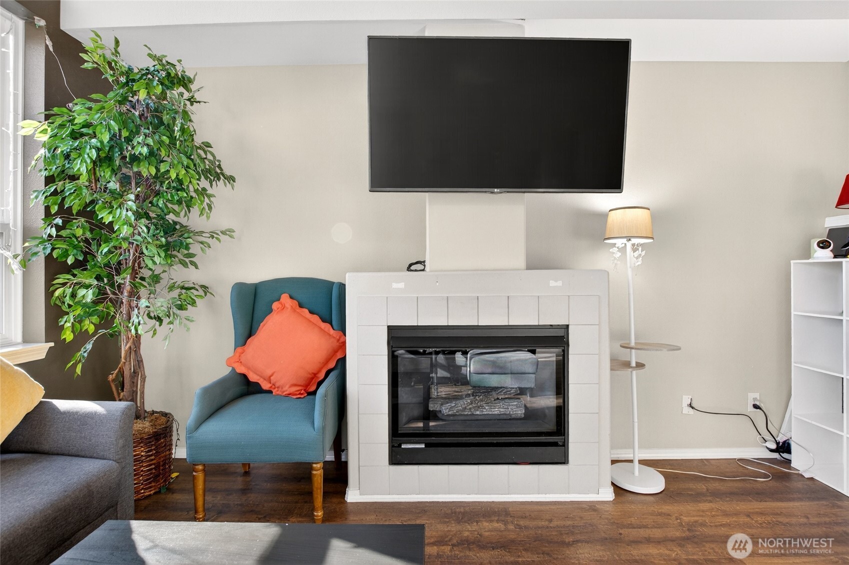 6615 South 239th Place, Unit R109 Kent, WA 98032 - Photo 9 of 40 a living room with furniture a flat screen tv and a fireplace