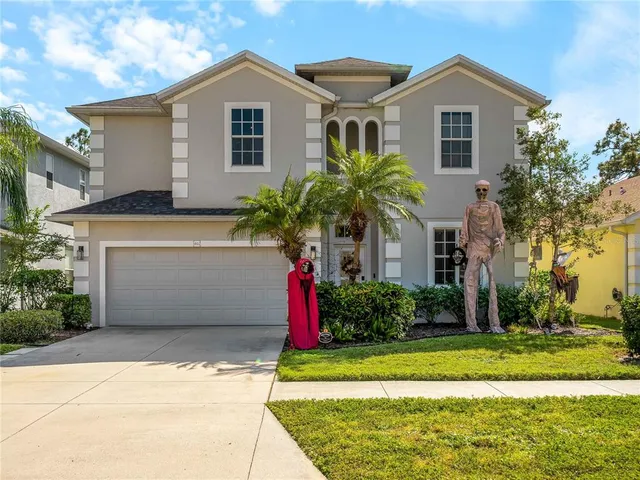 a front view of house with yard and trees