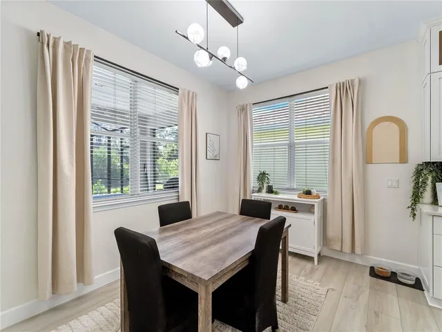 a view of a hallway with wooden floor and stairs