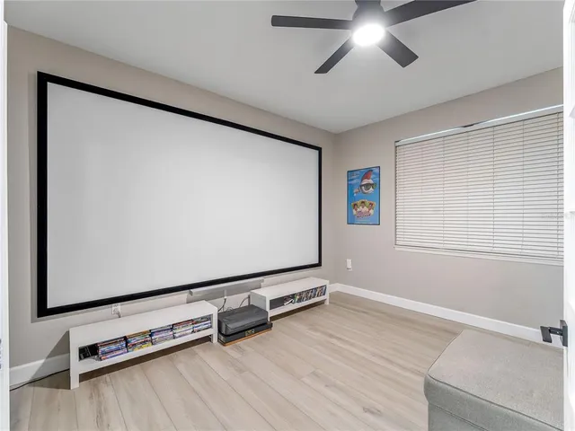 a living room with a bed furniture and a large window