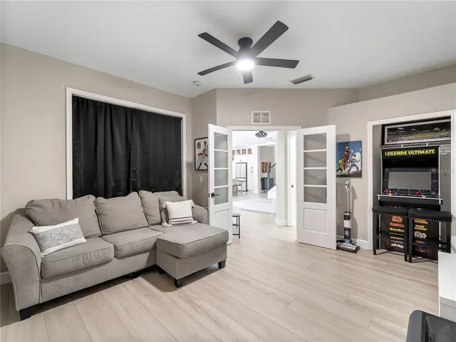 a bedroom with a large bed and a flat tv screen on dresser