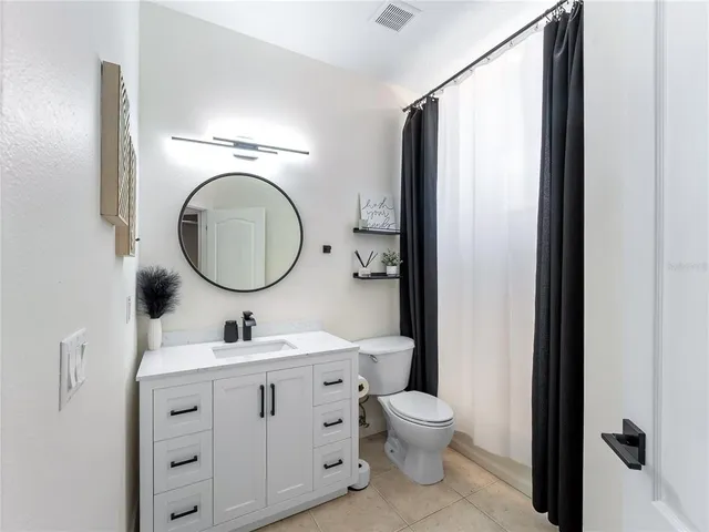 a bedroom with a bed and a television