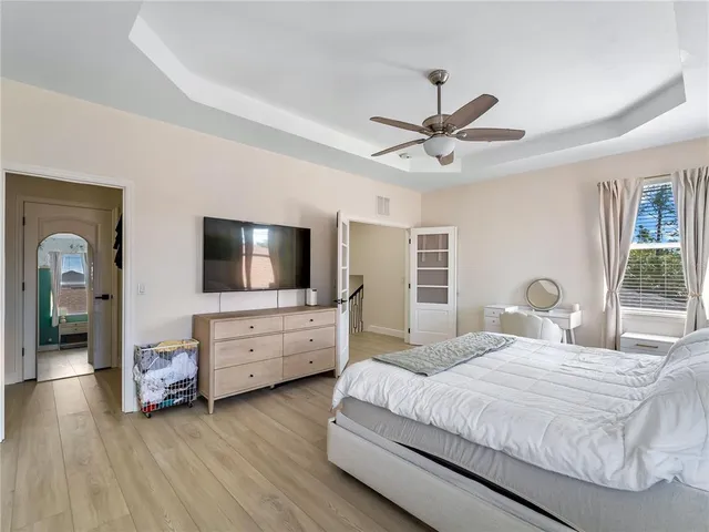 a bedroom with a bed and a chandelier