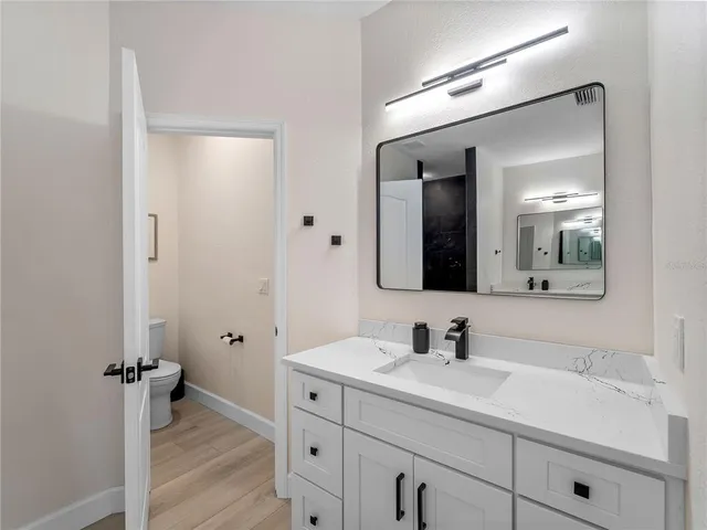 a living room with patio furniture and a floor to ceiling window