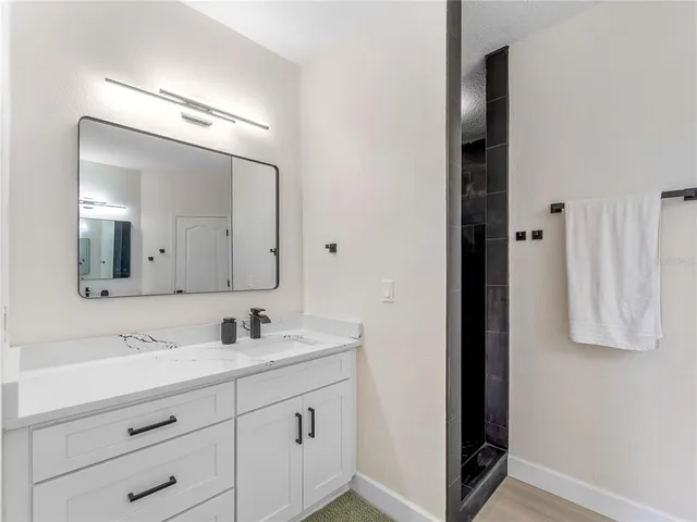 a living room with patio furniture and a floor to ceiling window