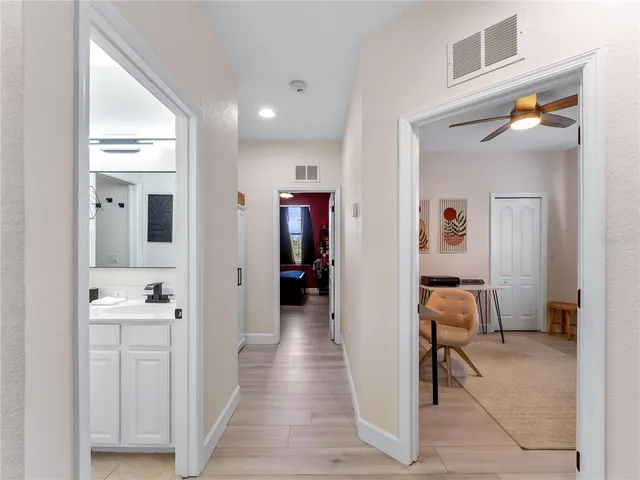 a view of a field with an trees in front of it