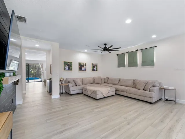 a living room with furniture and wooden floor