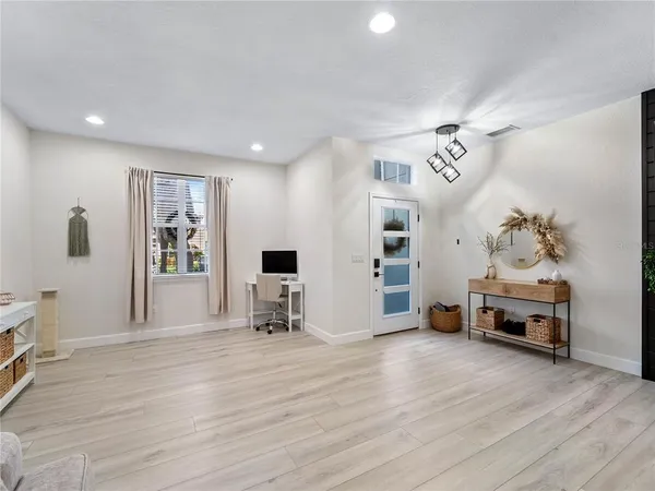 a view of a livingroom with furniture window and wooden floor