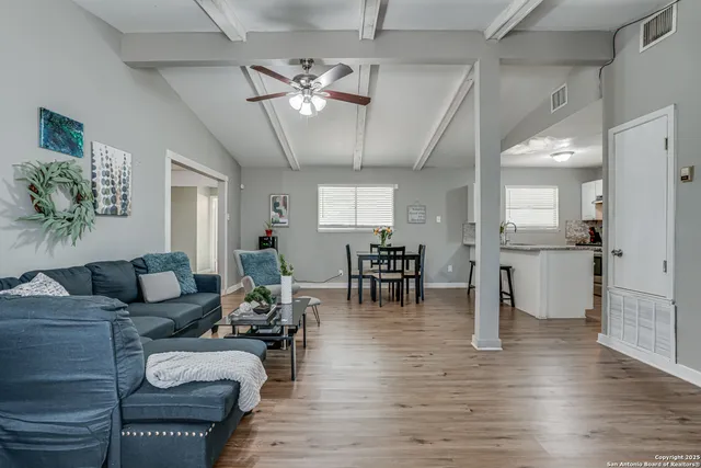 a living room with furniture and kitchen view