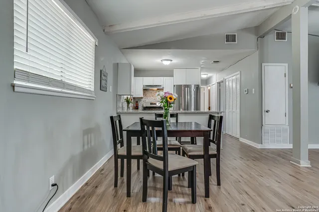 a view of a dining room with furniture and wooden floor