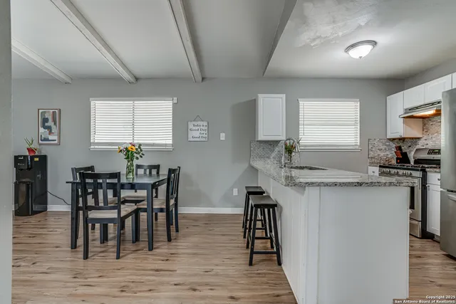 a view of a dining room with furniture and wooden floor