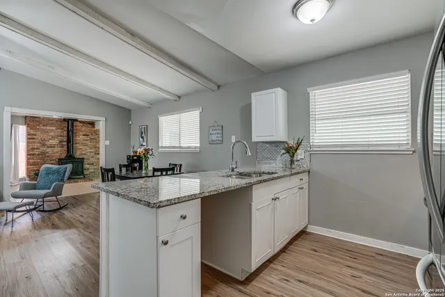 a kitchen with sink stove and cabinets
