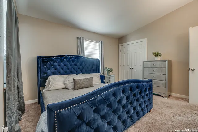 a bedroom with a bed and window