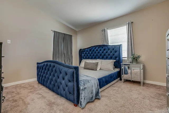 a bedroom with a bed and window