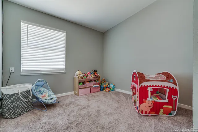 a living room with baby toys and a couch